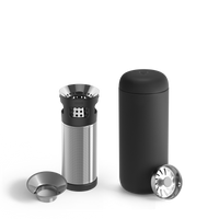 The Fellow Carter Infuser Set is a sleek black cylindrical coffee maker with a minimalist design for cold brew lovers. It features a disassembled stainless steel filter basket, two lids, smooth curves, and metallic accents, perfectly complementing the Carter Move Mug or tea infuser.